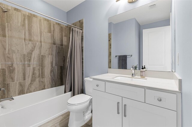 bathroom featuring shower / tub combo, visible vents, vanity, and toilet