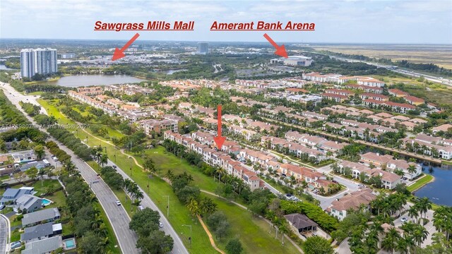 drone / aerial view with a city view and a water view