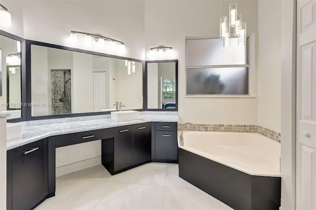 bathroom with tile patterned floors, a shower stall, a garden tub, and vanity