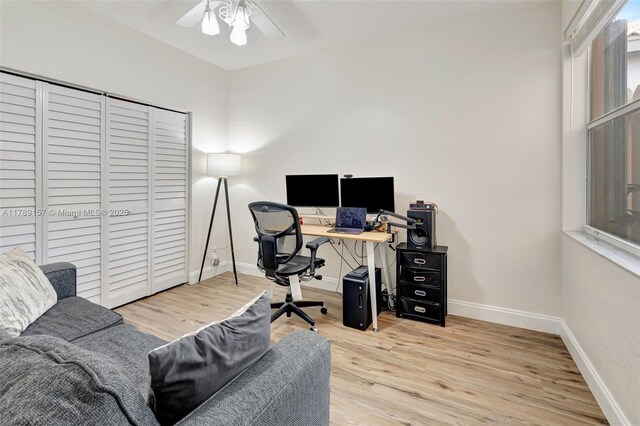 office space with wood finished floors, a ceiling fan, and baseboards