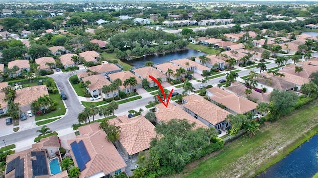 birds eye view of property featuring a residential view and a water view