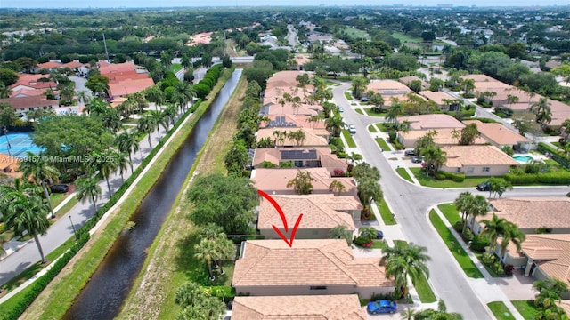 drone / aerial view with a water view and a residential view