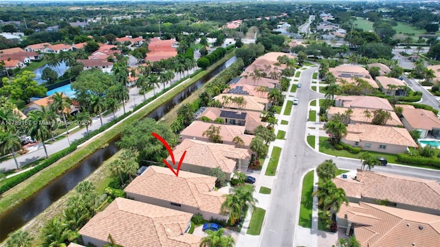 drone / aerial view with a water view and a residential view