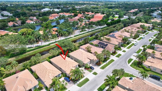 drone / aerial view with a water view and a residential view