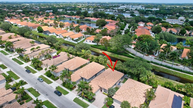 drone / aerial view with a water view and a residential view