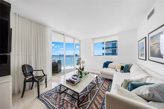 665 NE 25th St Unit 1201, Miami, FL 33137 - living area featuring a wall of windows, visible vents, and a water view