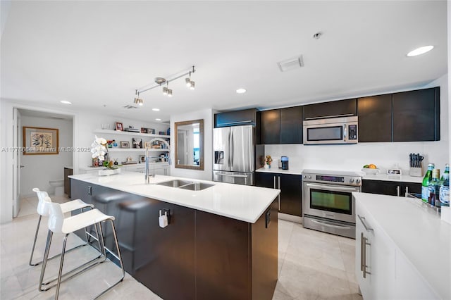 665 NE 25th St Unit 1201, Miami, FL 33137 - kitchen with stainless steel appliances, light countertops, a sink, and a kitchen bar