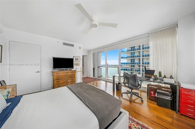 665 NE 25th St Unit 1201, Miami, FL 33137 - bedroom featuring visible vents, a ceiling fan, wood finished floors, and floor to ceiling windows