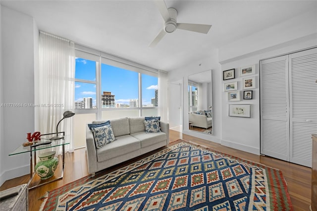 665 NE 25th St Unit 1201, Miami, FL 33137 - living area featuring wood finished floors, a ceiling fan, baseboards, and a view of city