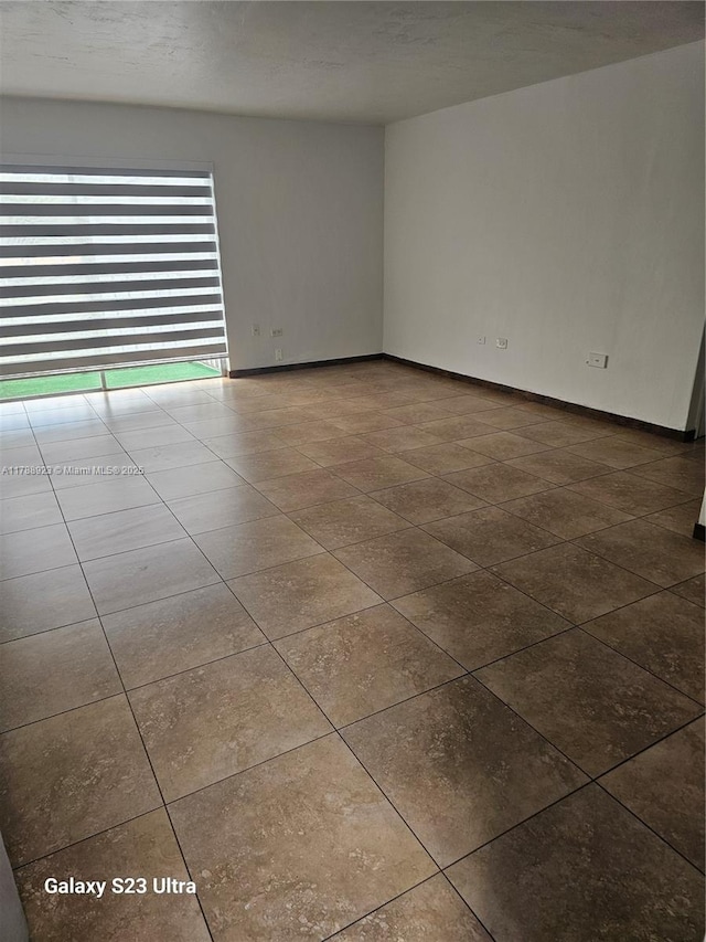 7250 SW 94th Pl Unit B8, Miami, FL 33173 - tiled empty room featuring baseboards