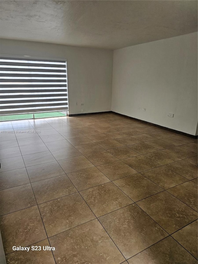 tiled spare room with baseboards