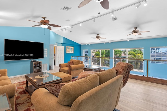 1146 SE 14th Ter, Deerfield Beach, FL 33441 - living area with rail lighting, a ceiling fan, vaulted ceiling, wood finished floors, and baseboards