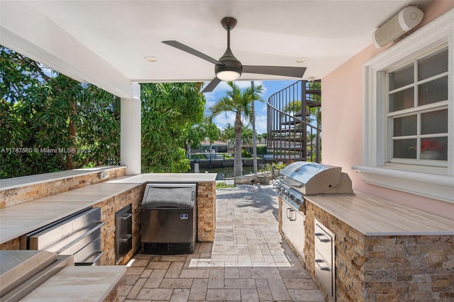 1146 SE 14th Ter, Deerfield Beach, FL 33441 - view of patio / terrace featuring stairway, exterior kitchen, area for grilling, and a ceiling fan