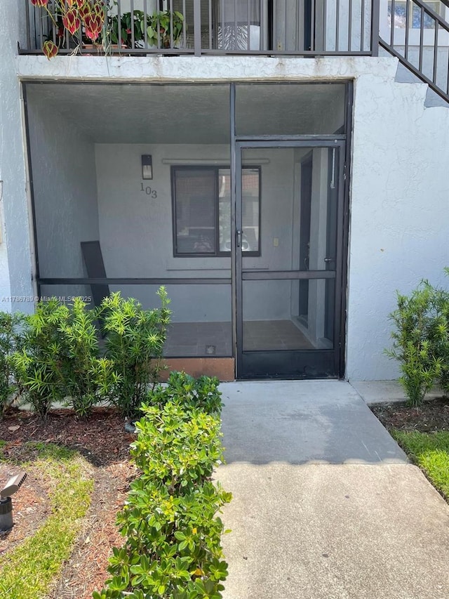 doorway to property with stucco siding