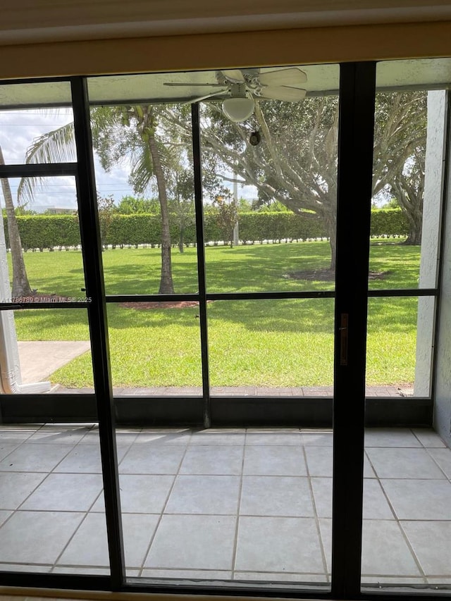unfurnished sunroom featuring a ceiling fan