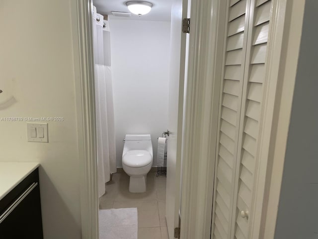 full bath with tile patterned flooring, toilet, and vanity