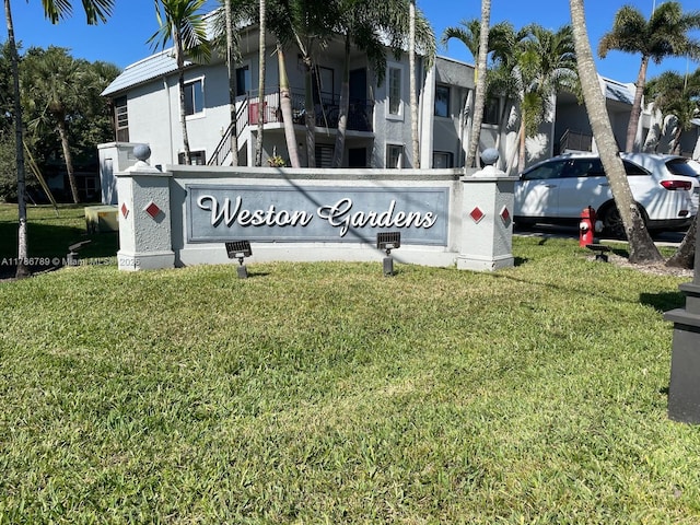 community sign featuring a yard