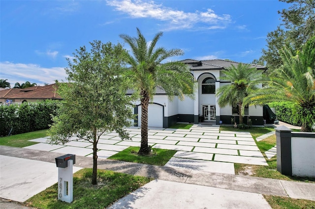 view of front of house featuring french doors, stucco siding, and a tile roof