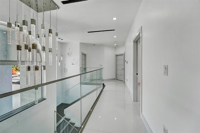 hallway featuring baseboards and recessed lighting