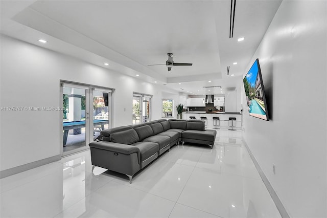 living room with light tile patterned flooring, ceiling fan, recessed lighting, and french doors
