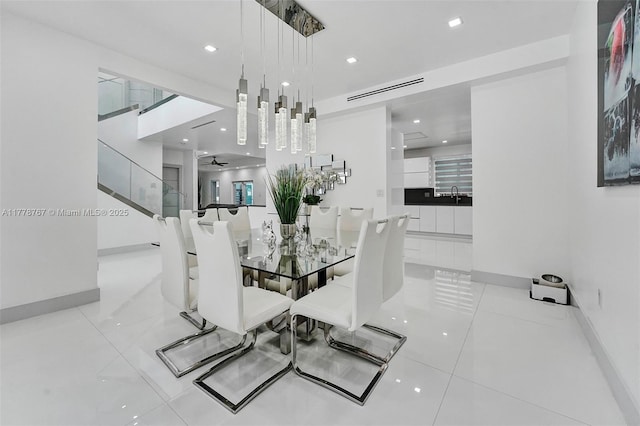 tiled dining room featuring recessed lighting and baseboards