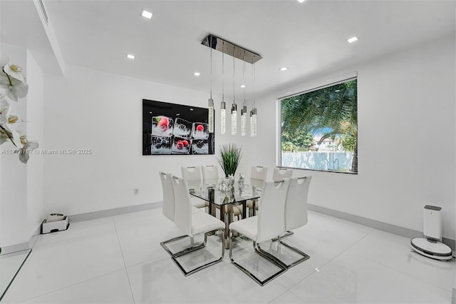 tiled dining area with recessed lighting and baseboards