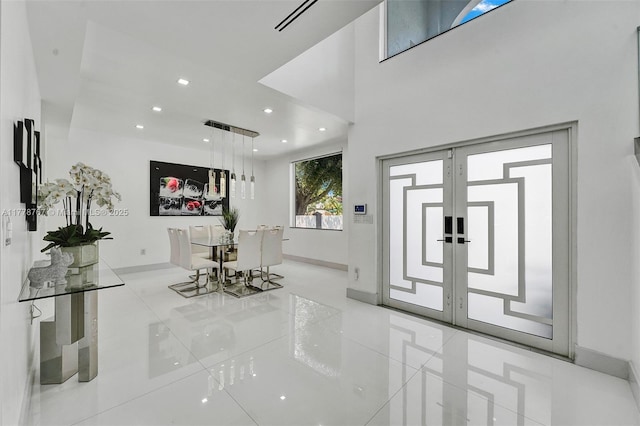 entrance foyer with recessed lighting, baseboards, and light tile patterned flooring