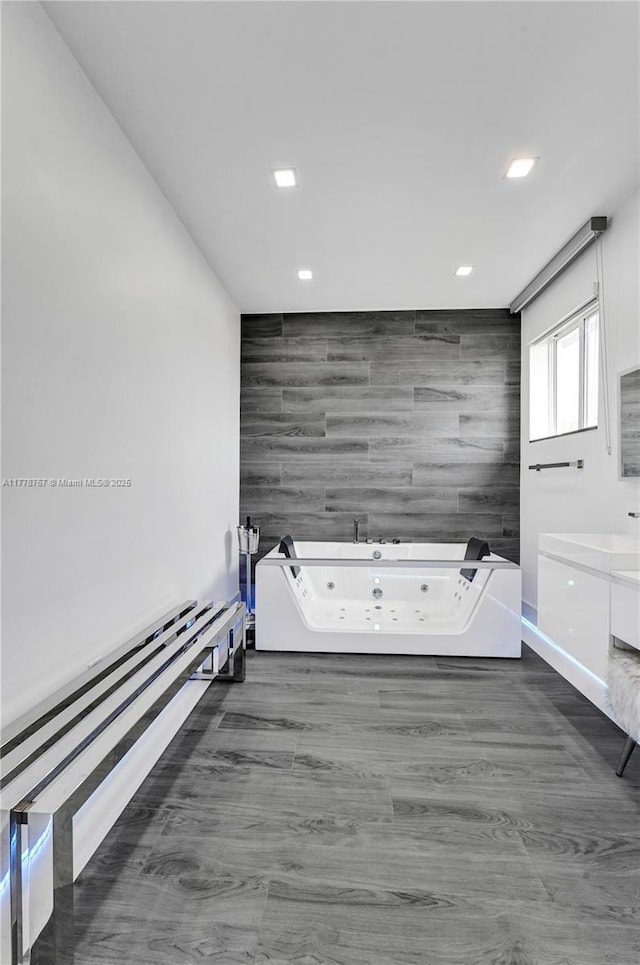 interior space featuring recessed lighting, baseboards, tile walls, and an accent wall