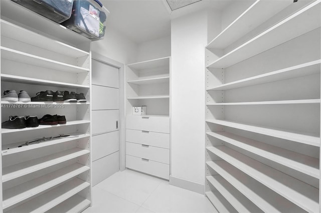 walk in closet featuring light tile patterned flooring