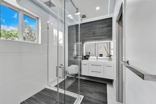 bathroom featuring vanity, a stall shower, toilet, and visible vents