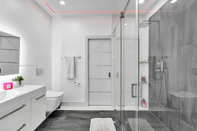 bathroom with vanity, toilet, and a shower stall