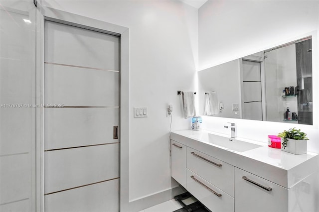 bathroom featuring baseboards and vanity
