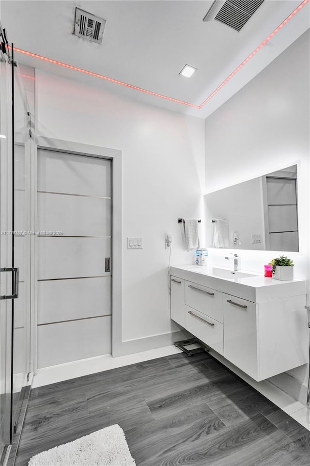 full bathroom featuring visible vents, wood finished floors, and vanity