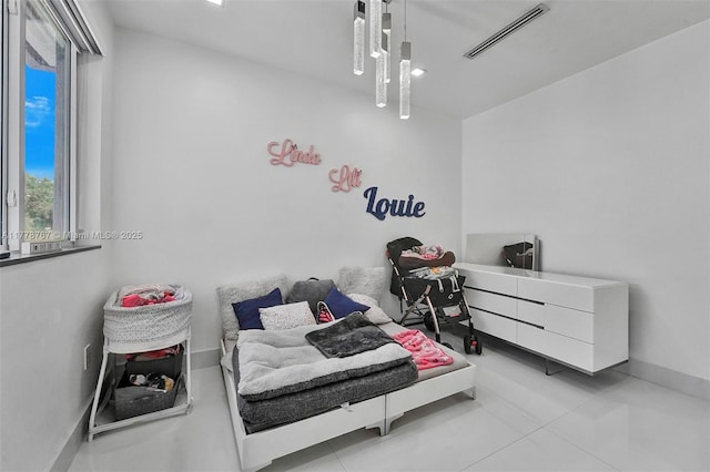 bedroom with baseboards, tile patterned flooring, and visible vents