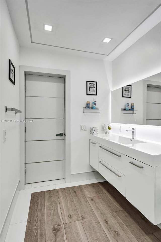 bathroom with vanity and wood finished floors