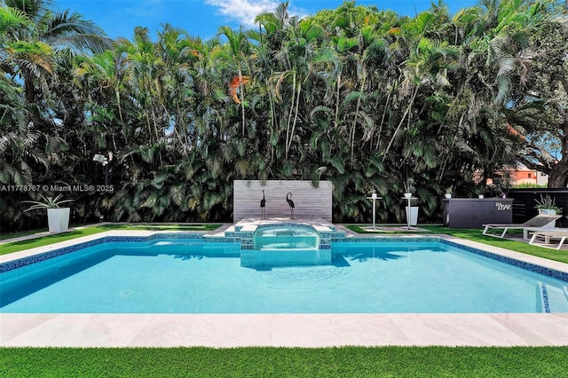 view of swimming pool featuring fence and a pool with connected hot tub