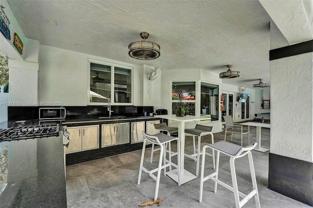 view of patio / terrace with a sink and exterior kitchen