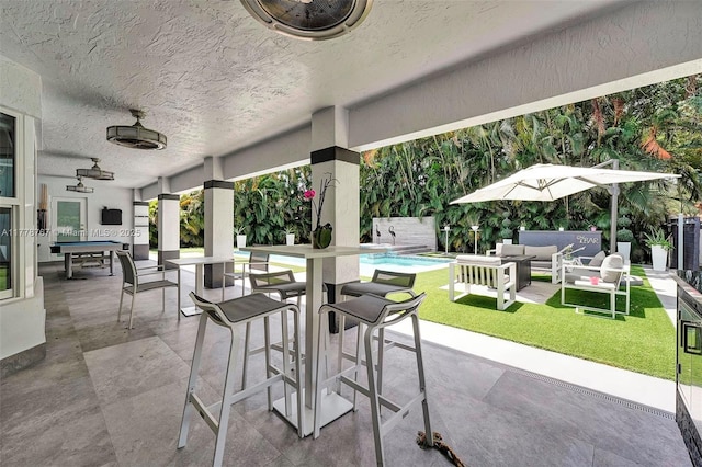 view of patio with an outdoor hangout area, outdoor dry bar, and a fenced in pool