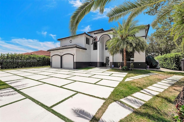 view of front of property featuring a garage, driveway, and stucco siding