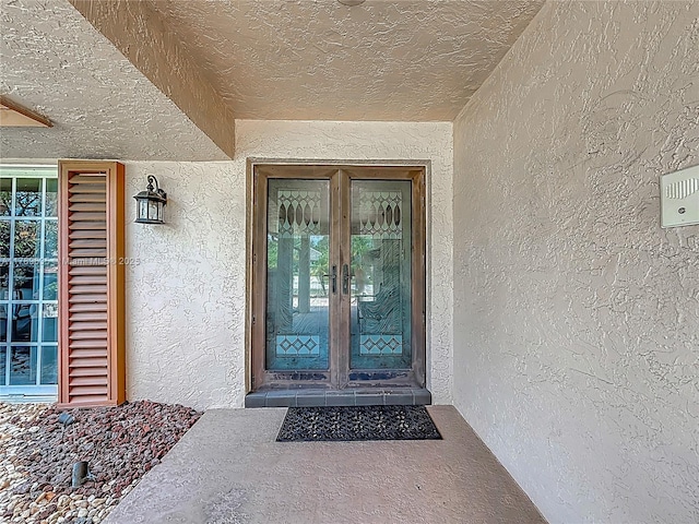 547 Deer Creek Run, Deerfield Beach, FL 33442 - view of exterior entry featuring french doors and stucco siding