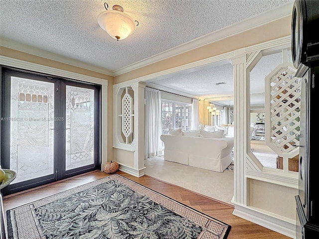 547 Deer Creek Run, Deerfield Beach, FL 33442 - foyer featuring wood finished floors, visible vents, french doors, crown molding, and a textured ceiling