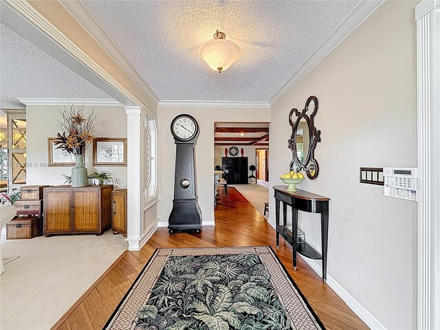 547 Deer Creek Run, Deerfield Beach, FL 33442 - foyer with light wood-type flooring, a textured ceiling, crown molding, and decorative columns