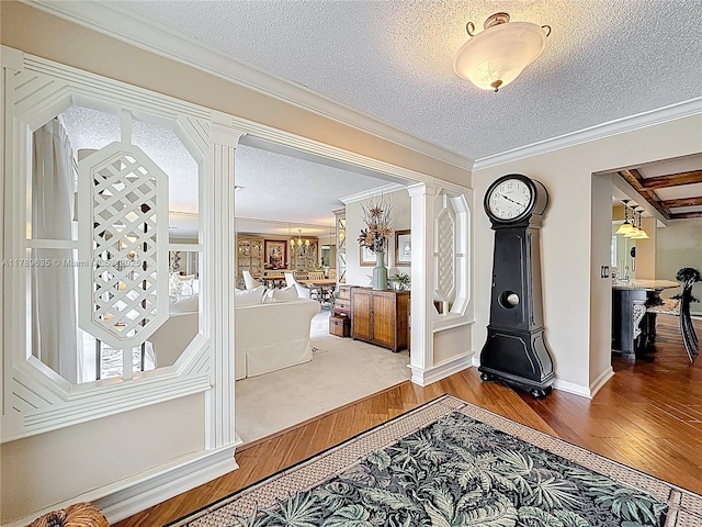 547 Deer Creek Run, Deerfield Beach, FL 33442 - entryway with ornamental molding, wood-type flooring, baseboards, decorative columns, and a textured ceiling
