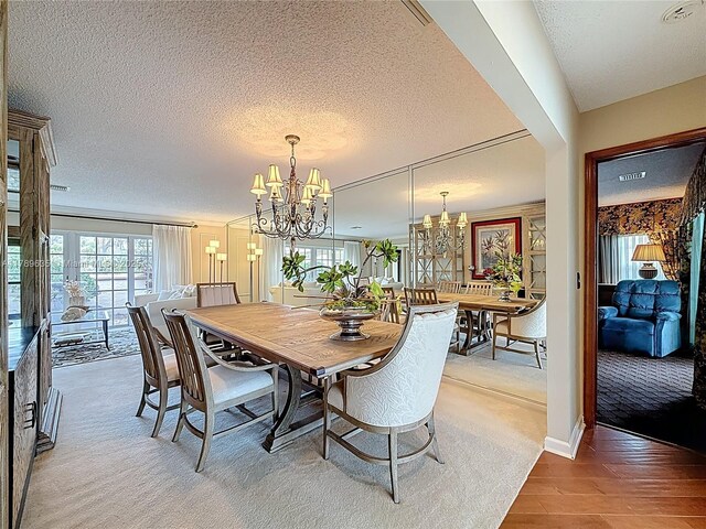 547 Deer Creek Run, Deerfield Beach, FL 33442 - dining space featuring wood finished floors, a textured ceiling, and a chandelier
