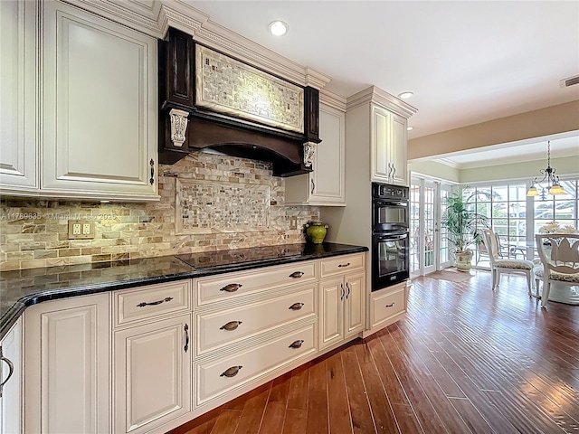 547 Deer Creek Run, Deerfield Beach, FL 33442 - kitchen with dark countertops, black appliances, custom range hood, backsplash, and dark wood-style flooring