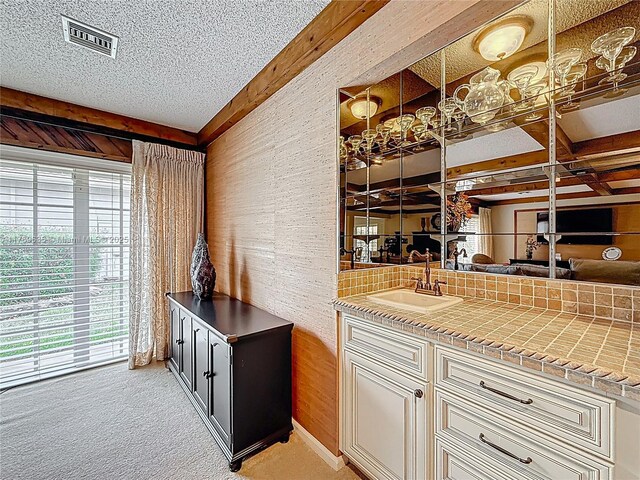 547 Deer Creek Run, Deerfield Beach, FL 33442 - bar featuring visible vents, light carpet, a sink, a textured ceiling, and indoor wet bar