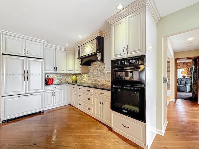 547 Deer Creek Run, Deerfield Beach, FL 33442 - kitchen with recessed lighting, tasteful backsplash, light wood-style flooring, and black appliances