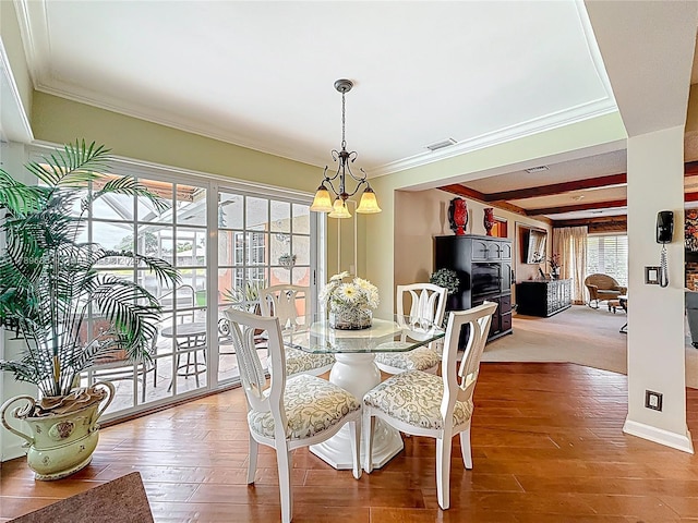 547 Deer Creek Run, Deerfield Beach, FL 33442 - dining room with an inviting chandelier, crown molding, hardwood / wood-style floors, and visible vents