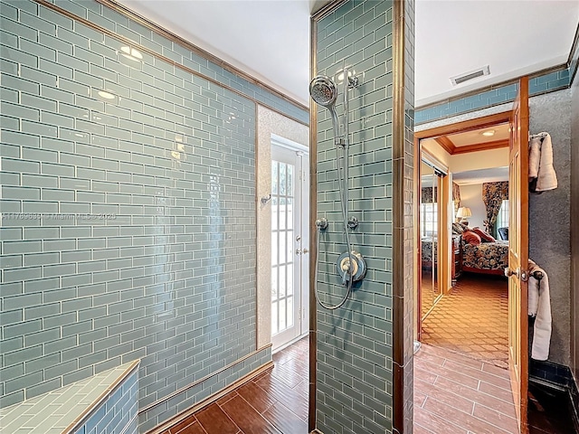 547 Deer Creek Run, Deerfield Beach, FL 33442 - bathroom with tiled shower, visible vents, wood finished floors, ensuite bath, and ornamental molding