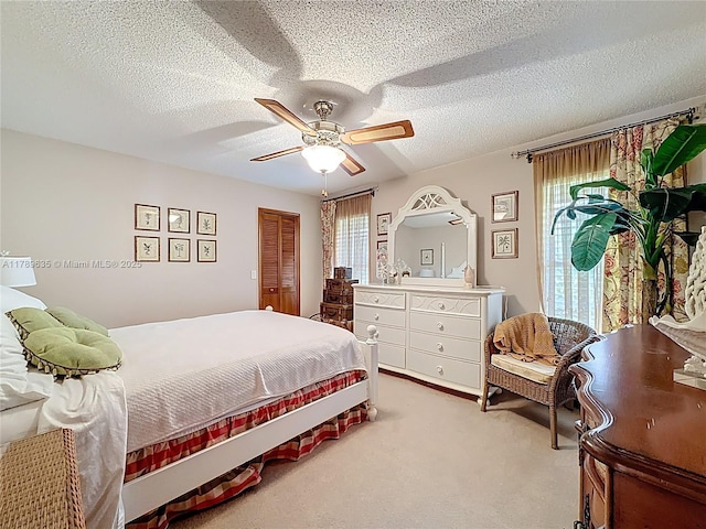 547 Deer Creek Run, Deerfield Beach, FL 33442 - bedroom featuring light carpet, a textured ceiling, a closet, and ceiling fan